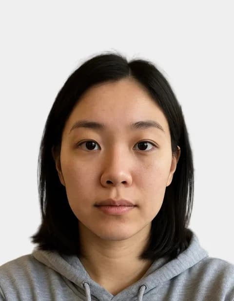 The same person as a UK passport photo on a plain background
